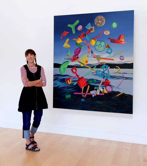 Artist Karen Hackenberg in her Discovery Bay home studio with her painting titled “The Floating World.” (photo by Craig Wester)
