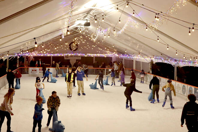 Skaters glide across the Winter Ice Village on Front Street in downtown Port Angeles. The Winter Ice Village, operated by the Port Angeles Chamber of Commerce, is open daily from noon to 9 p.m. through Jan. 5. (Dave Logan/for Peninsula Daily News)