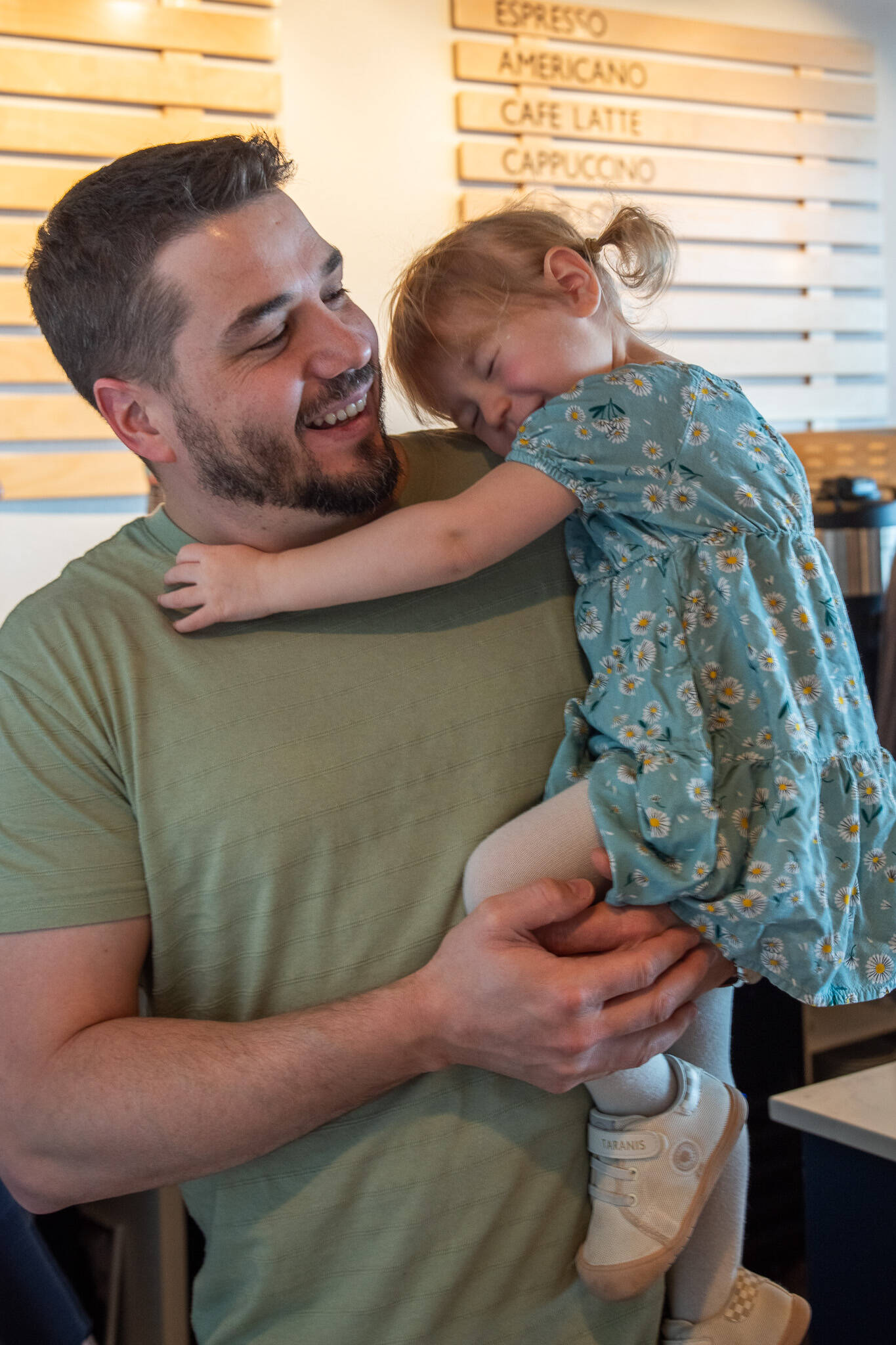 Rod Dirks enjoys affection from his 2-year-old daughter Maeli, who expresses confidence that doctors will heal her dad’s cancer. (Emily Matthiessen/Olympic Peninsula News Group)