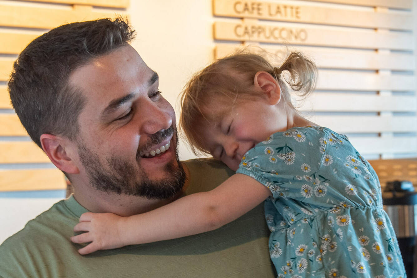 Rod Dirks enjoys affection from his 2-year-old daughter Maeli, who expresses confidence that doctors will heal her dad’s cancer. (Emily Matthiessen/Olympic Peninsula News Group)