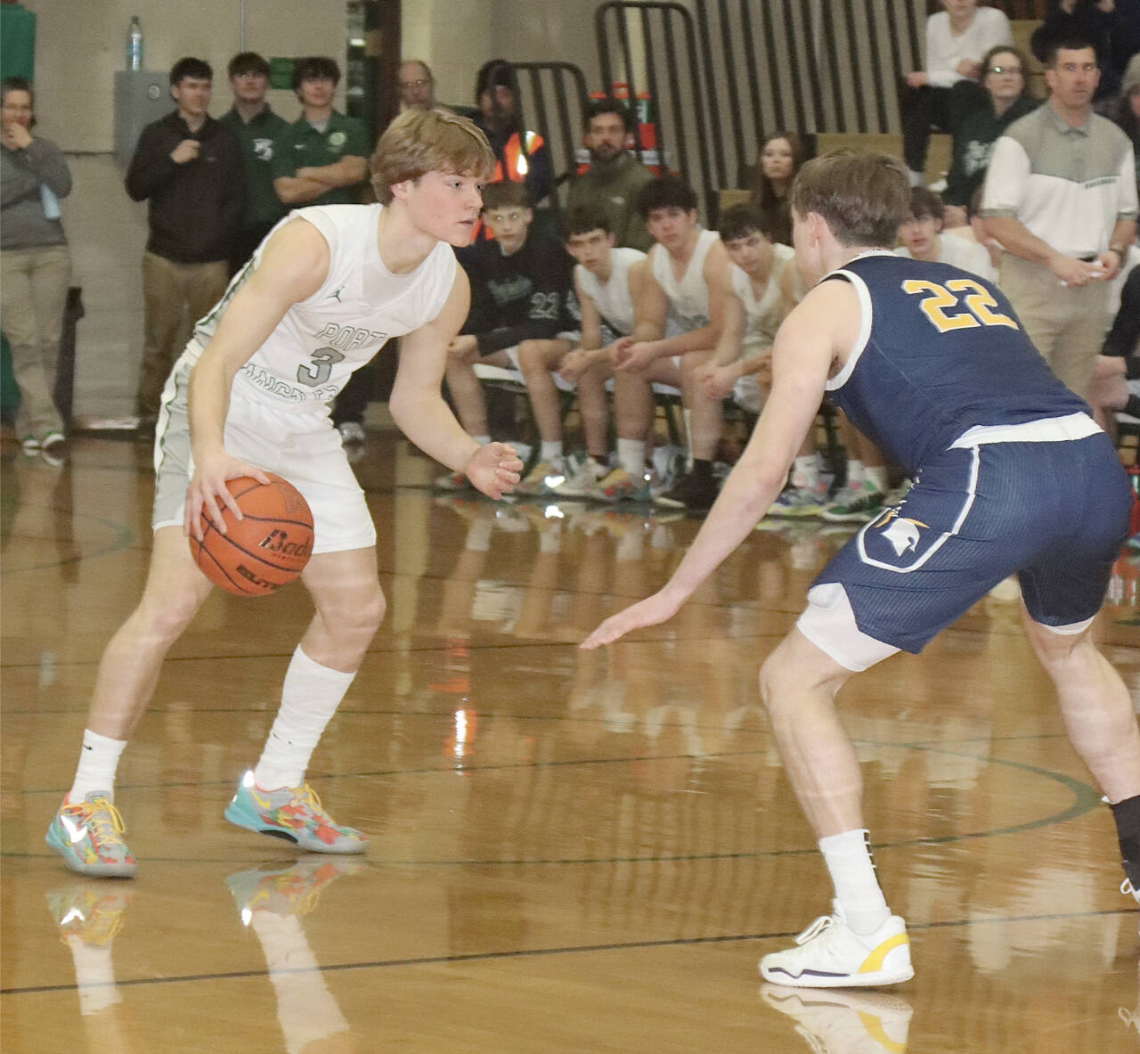 Port Angeles’ Gus Halberg goes up against Bainbridge’s Luke Johnson (22) on Tuesday in Port Angeles. The Roughriders hung tough with the Spartans, but fell 41-38. (Dave Logan/for Peninsula Daily News)