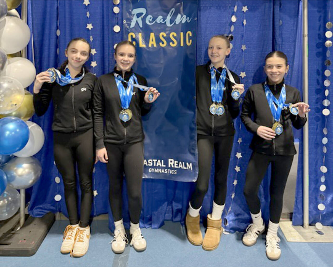 The Klahhane Xcel Gold team from left, includes Lainey DePiro, Raynee Ciarlo, Lorelei Sanders and Emily Bair. Four out of the six Xcel Gold members got 9.0 or higher in the floor exercise at the Realm Classic meet in Everett this weekend. (Klahhane Gymnastics)