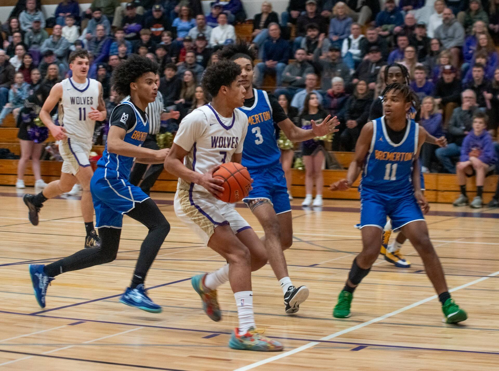 Emily Matthiessen/Olympic Peninsula News Group 
Sequim’s Solomon Sheppard is surrounded in the paint by three Bremerton basketball players during a contest Monday at Rick Kaps Gymnasium.