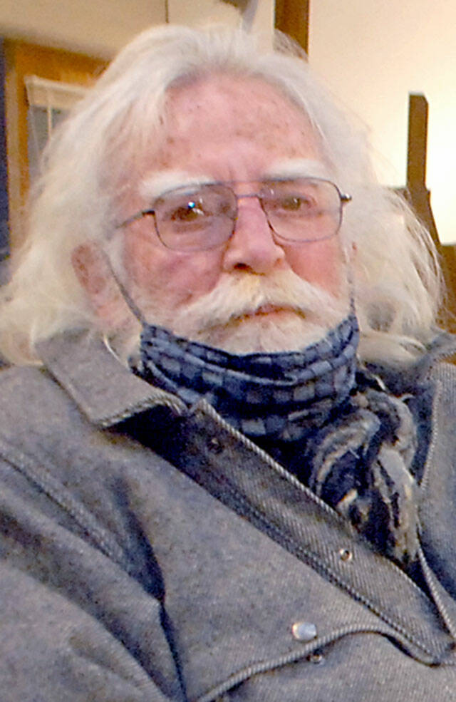Port Angeles artist Bob Stokes sits in his studio and music venue on Wednesday. (Keith Thorpe/Peninsula Daily News)