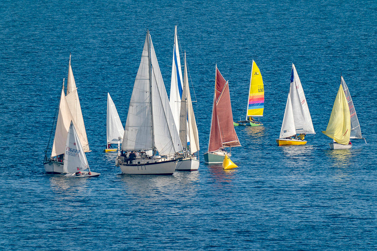 Sailboats jam up going around the first mark during a race on Port Townsend Bay on Saturday. After being delayed a week due to stormy weather, 30 boats took to the calmer waters of Port Townsend Bay for the 34th Shipwrights’ Regatta hosted by the Port Townsend Sailing Association. (Steve Mullensky/for Peninsula Daily News)