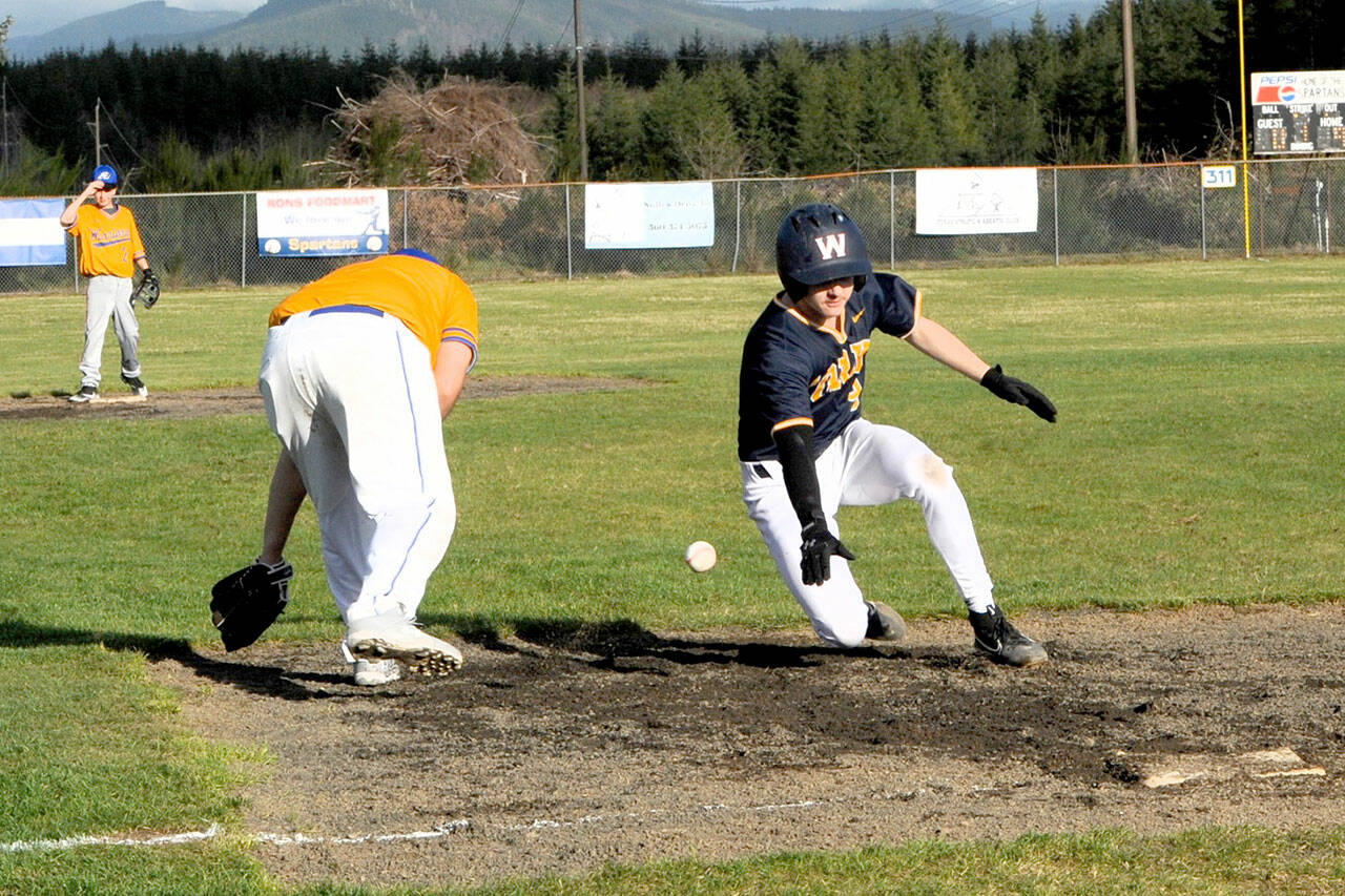 Spartan Landen Olson slides into third with a triple then scores on an overthrow. Photo by Lonnie Archibald.