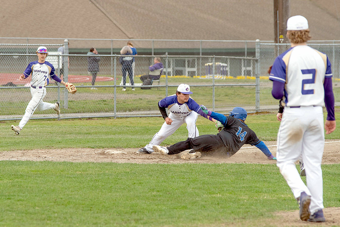 Emily Matthiessen/Olympic Peninsula News Group
Sequim's Duran Ward applies the tag to North Mason's Boston Stanley as Sequim's Simon Skribner backs up the play and pitcher Zeke Schmadeke, right, looks on.