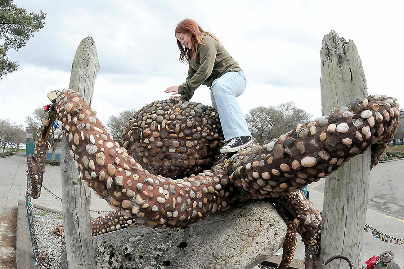 KEITH THORPE/PENINSULA DAILY NEWS
Violet Morris, 9, of Port Angeles climbs on "The Rocktopus," a steel, rock and masonry sculpture on Friday  at Port Angeles City Pier. The sculpture was originally designed by artist Oliver Strong as a topiary creation, but was later reworked with stone and mortar by artist Maureen Wall with support from Soroptimist International Port Angeles Jet Set, the City of Port Angeles and the Girl Scouts.