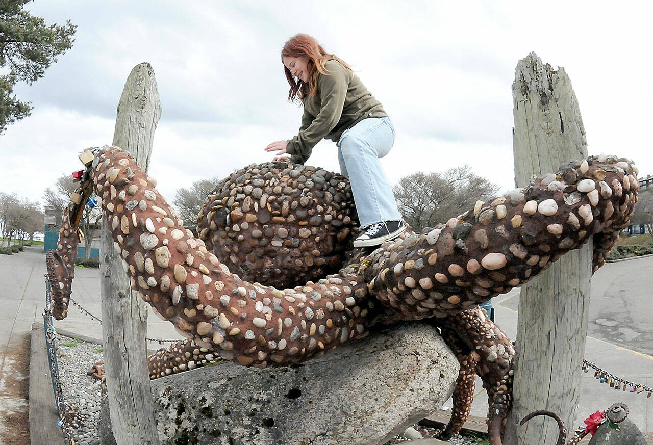 Violet Morris, 9, of Port Angeles climbs on “The Rocktopus,” a steel, rock and masonry sculpture on Friday at Port Angeles City Pier. The sculpture was originally designed by artist Oliver Strong as a topiary creation, but was later reworked with stone and mortar by artist Maureen Wall with support from Soroptimist International Port Angeles Jet Set, the City of Port Angeles and the Girl Scouts. (KEITH THORPE/PENINSULA DAILY NEWS)