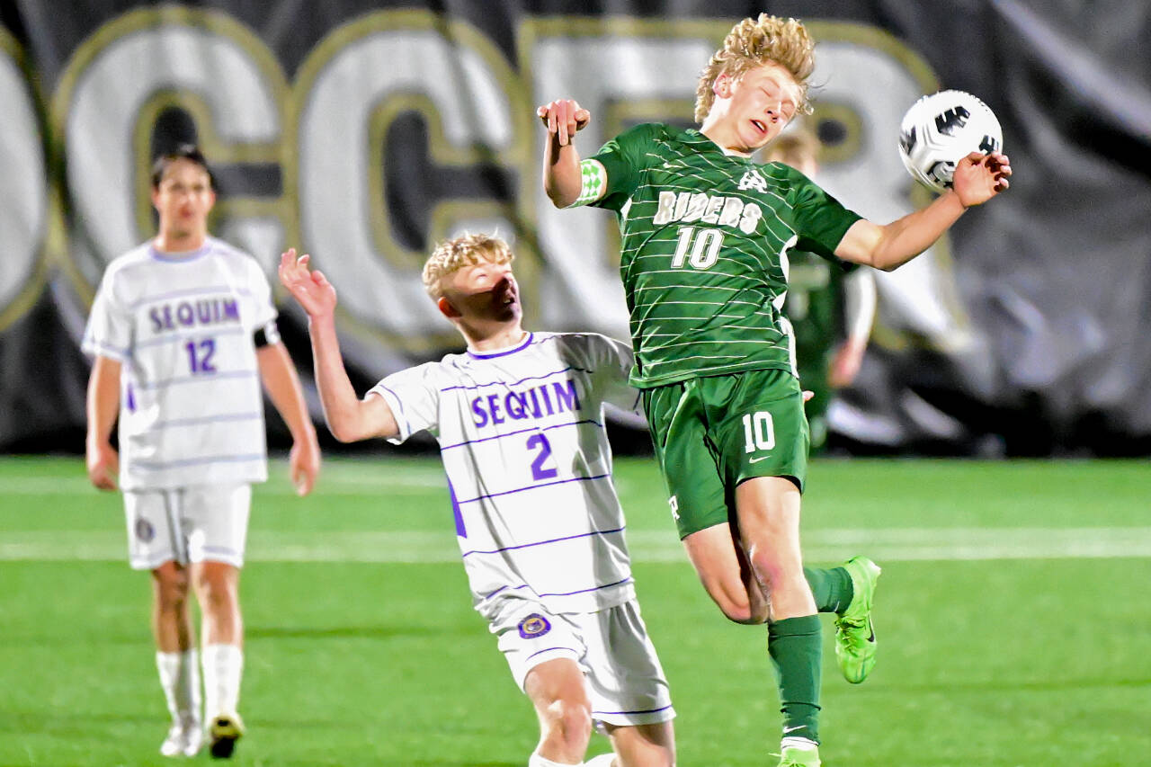 Port Angeles' Matthew Miller heads the ball at Wally Sigmar Field on Tuesday as Sequim's Joshua Alcaraz (2) and Preston Kurtze are in on the play. Miller scored two goals in a 2-1 victory. (Jay Cline/for Peninsula Daily News)