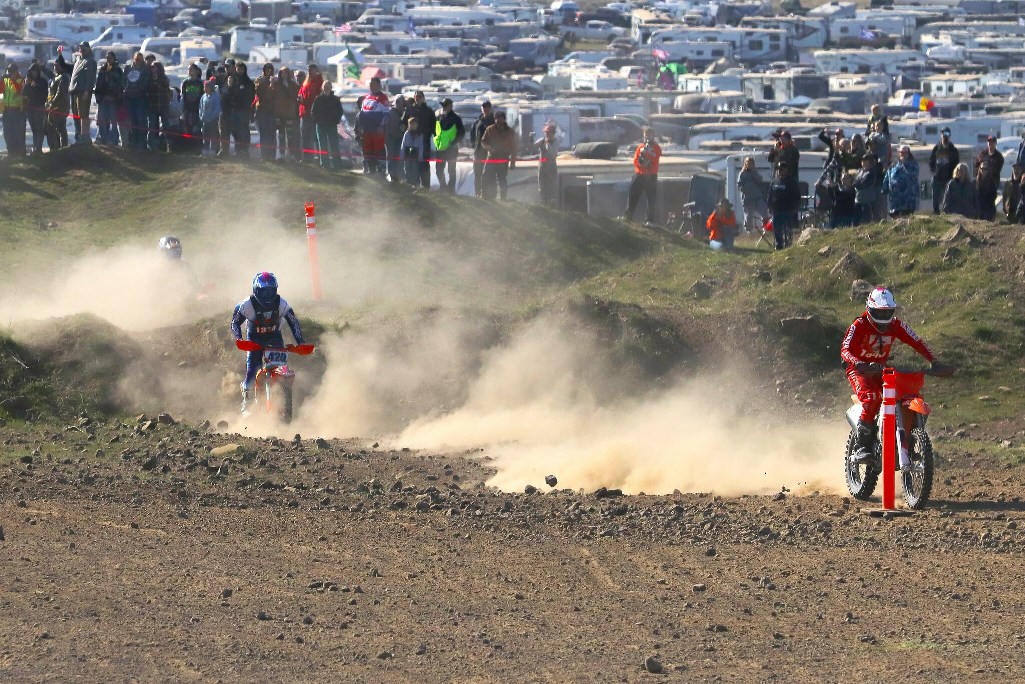 Roger Harnack/Cheney Free Press
Clayton Ernst of Port Angeles, right, rides through the holeshot leading to the Desert 100 motorcycle races’ first turn last Sunday near Odessa. Ernst went on to win the 386-participant overall 50-mile race along with his 15-and-younger age division on his KTM.