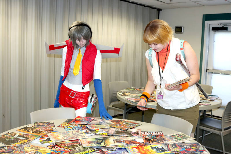 In the comic book swap corner of the Squatchcon convention are Raiden Stuntz, left, as Starscream and Quinn Valentine as Cheryl Mason, both from Port Angeles. (Dave Logan/for Peninsula Daily News)