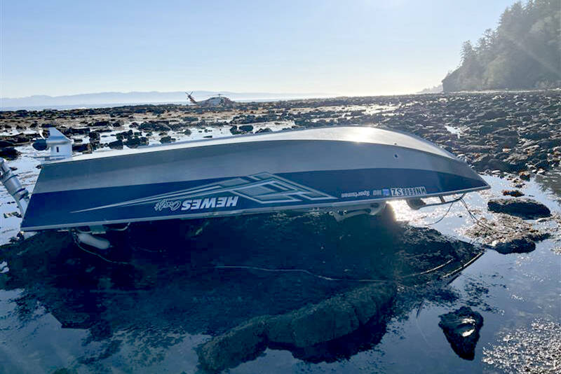 A 15-foot pleasure craft sits capsized at Koitlah Point on Thursday. U.S Coast Guard, local and federal agencies responded to a report of an overdue vessel with three people on board after they failed to return Wednesday evening. (U.S. Coast Guard)