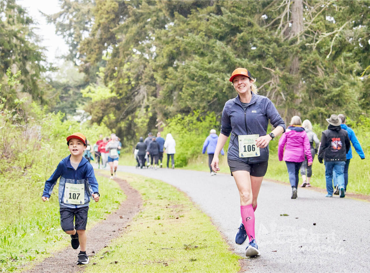 Sequim’s Chrissy Brown (106) runs the Railroad Bridge Run 5K last year in Sequim with her 8-year-old son. More than 450 people are expected to participate in this year’s sixth annual race. (Run the Peninsula)