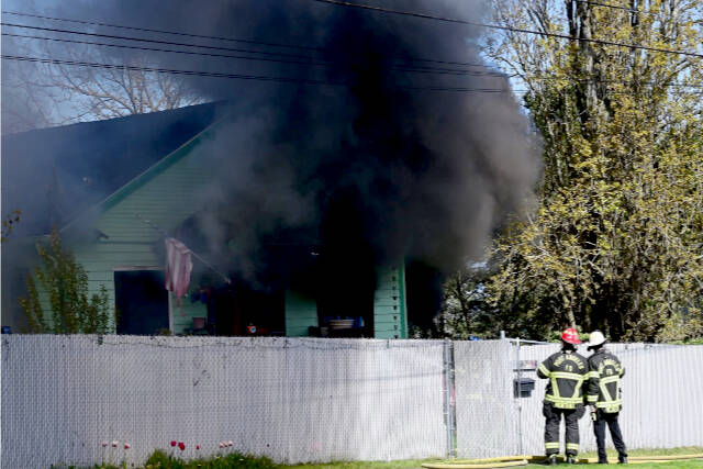 Port Angeles Fire Department responds to a residential structure fire on West 8th Street in Port Angeles. (Jay Cline)