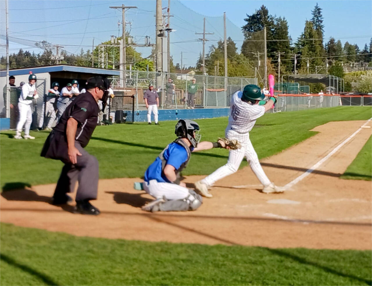 Port Angeles’ Trae Hanan hits a single to begin a big rally in the sixth inning against Olympic on Tuesday. Port Angeles won 5-2, then dropped an eight-inning game 6-5 to Bainbridge later in the night. (Pierre LaBossiere/for Peninsula Daily News