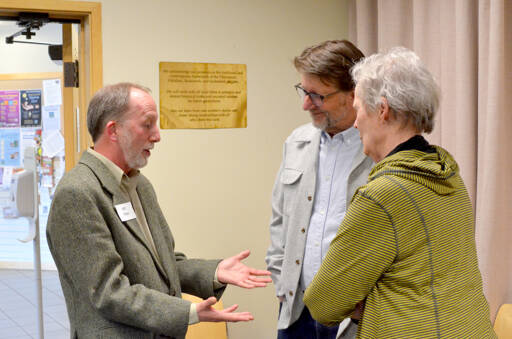 Josh Peters, left, in conversation with two attendees at Tuesday night’s event in the Humphrey room at Jefferson County Library District. (Elijah Sussman/Peninsula Daily News)
