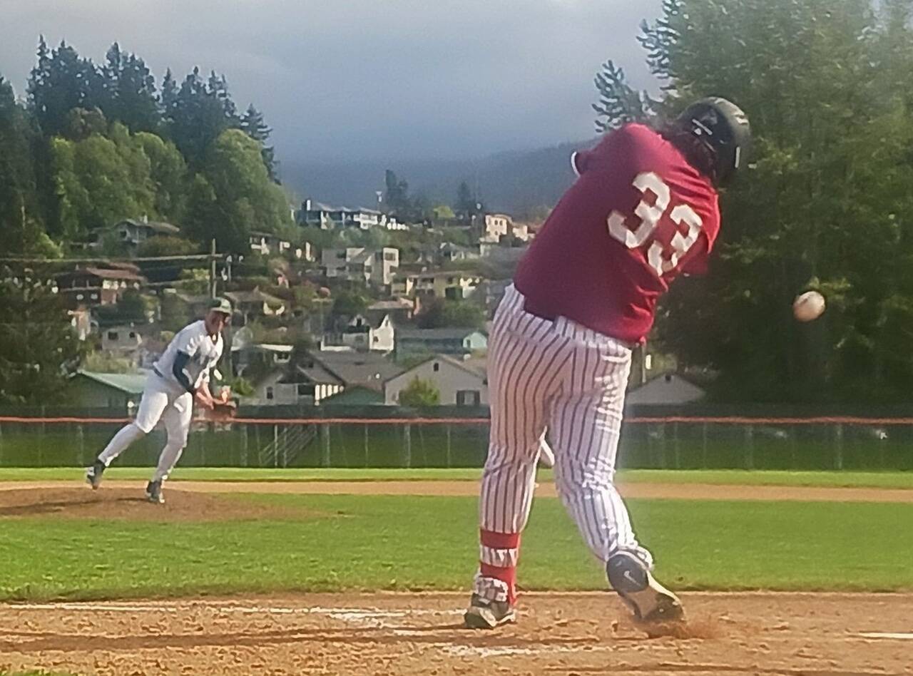 Port Angeles’ Braedyn Boulden-Davis delivers a pitch fouled off by Kingston’s Joel Jones (33) on Wednesday at Civic Field in Port Angeles. The Roughriders won the regular season finale 7-6 in nine innings, overcoming some gusty weather conditions. (Pierre LaBossiere/Peninsula Daily News)