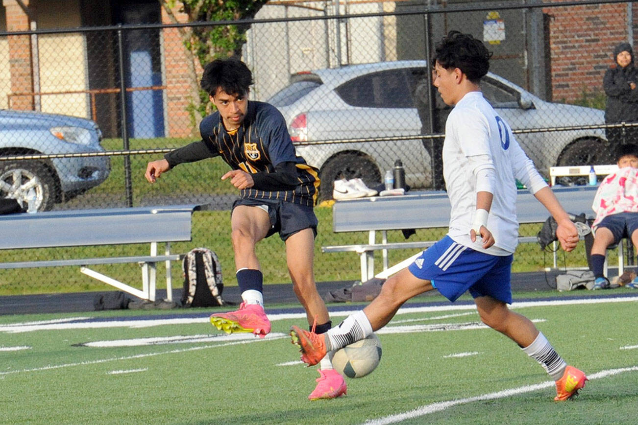 Forks Spartan Margarito Gonzalez (left) competes with Elma's Luis Torres for ball control Thursday evening on the turf of Spartan Stadium in this league contest. Photo by Lonnie Archibald.