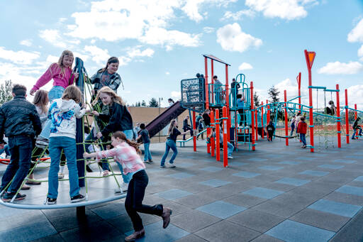 Chimacum Elementary School sixth-grade students jump on a rotating maypole as they use the new playground equipment on Monday during recess. The playground was redesigned with safer equipment and was in use for the first time since inspections were completed last Thursday. (Steve Mullensky/for Peninsula Daily News)