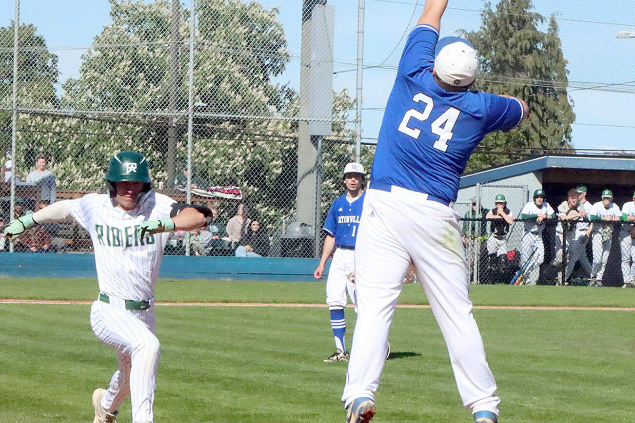 Port Angeles’ Ian Smithson reaches first baseball safely as the throw to the Eatonville first baseman was high and pulled him off the bag. Port Angeles won 8-1 to stay alive in the District 3 tournament. (Dave Logan/for Peninsula Daily News)