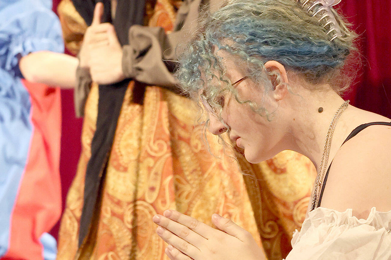 Port Angeles High School senior Madison McIntyre, foreground, will play Catherine of Aragon in “Queens.” Jayden Luabena, also a senior, will play King Henry VIII, and junior Felix Bubb will play the court fool. (Bear Pearcy)
