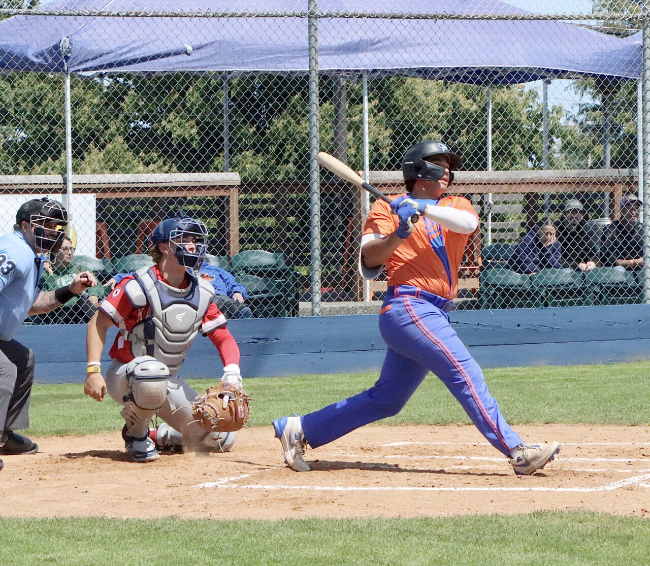 Port Angeles' Dom Dominguez gets a hit for an RBI against Kamloops at Civic Field on Sunday. (Dave Logan/for Peninsula Daily News)