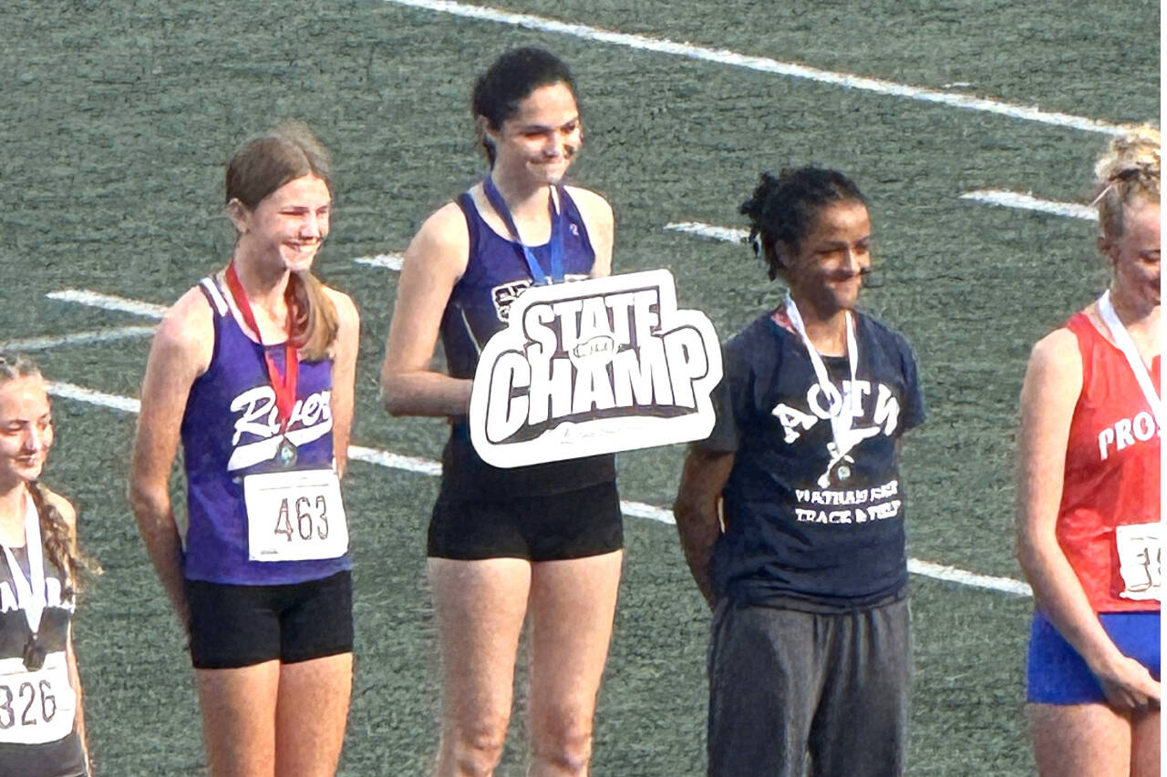 Sequim's Clare Turella is awarded first place in the state 2A track and field meet at Mount Tahoma Stadium in Tacoma in the girls' high jump. Turella jumped 5 feet, 4 inches to win the state championship for the second straight year. (Courtesy of Brad Moore)