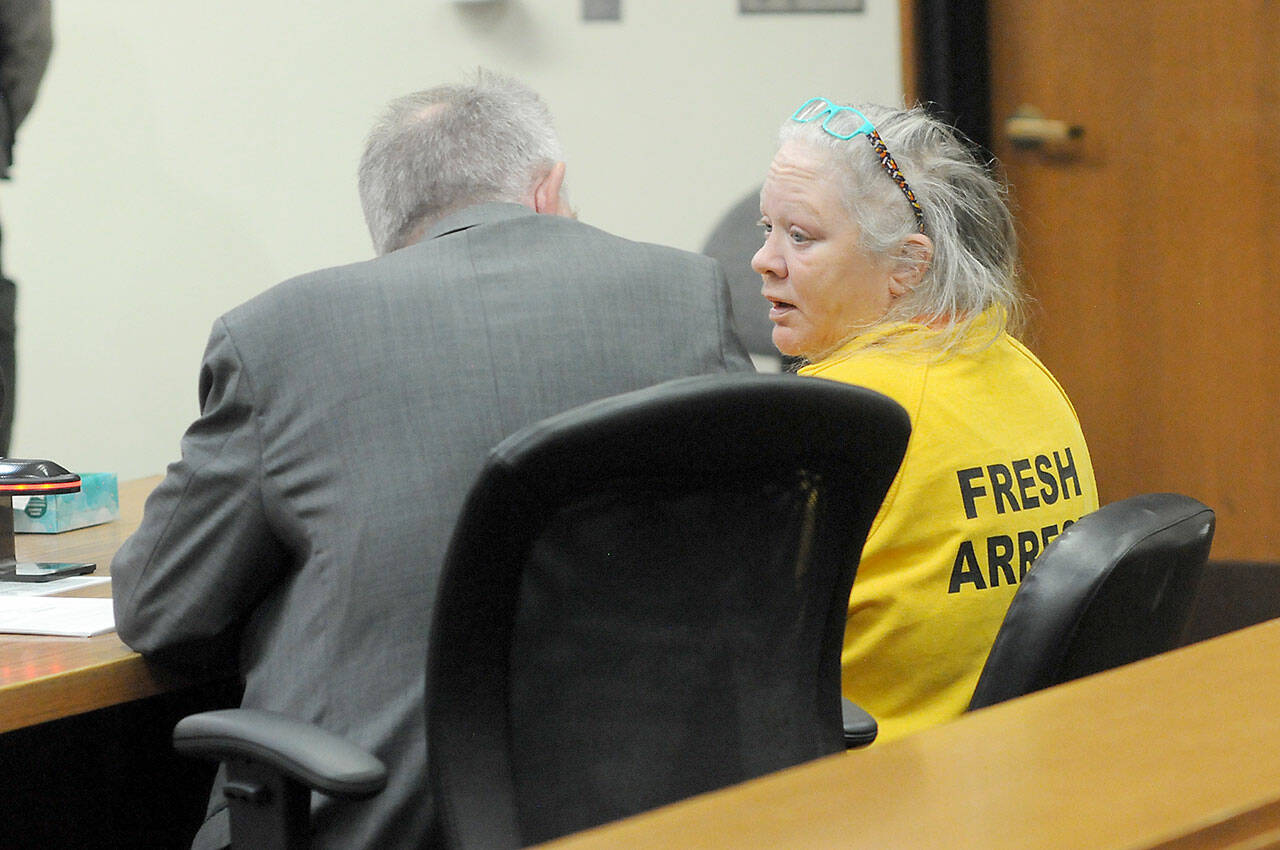 Tina Marie Alcorn, right, talks with attorney John Hayden during Alcorn’s first appearance on Tuesday in Clallam County Superior Court after extradition from Arkansas in connection with the 2016 homicide of George Cecil David in Port Angeles. (Keith Thorpe/Peninsula Daily News)
