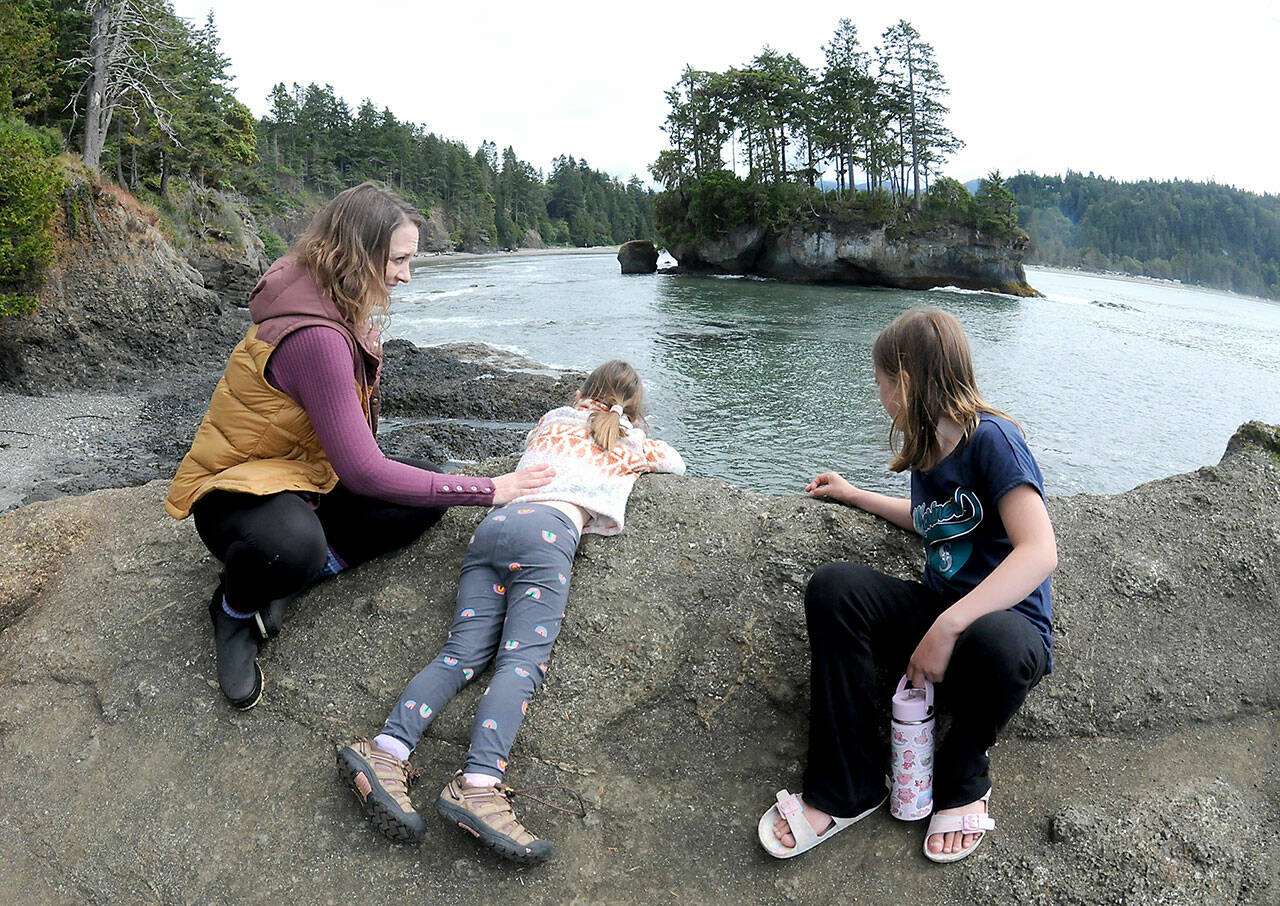 Carissa Guiley of Silverdale, left, along with daughters Mia Guiley, 5, and Evelyn Guiley, 8, peer over a rocky bluff at a sea stack in Crescent Bay on Saturday near Port Crescent. The family was on an outing at Salt Creek County Recreation Area. (Keith Thorpe/Peninsula Daily News)