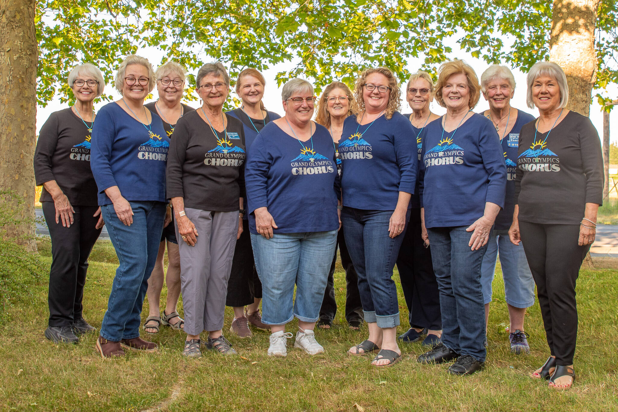 Emily Matthiessen/Olympic Peninsula News Group
Some of the 19 members of the women’s barbershop Grand Olympics Chorus pose outside their headquarters near QFC in Sequim during a rehearsal wearing their “Most Improved Chorus” necklaces won at the Sweet Adelines Region 13 contest in Spokane last month. Group members said they have plenty of room for more singers in the chorus. Those interested are welcome to attend a Monday evening practice, either to observe or sing with them.