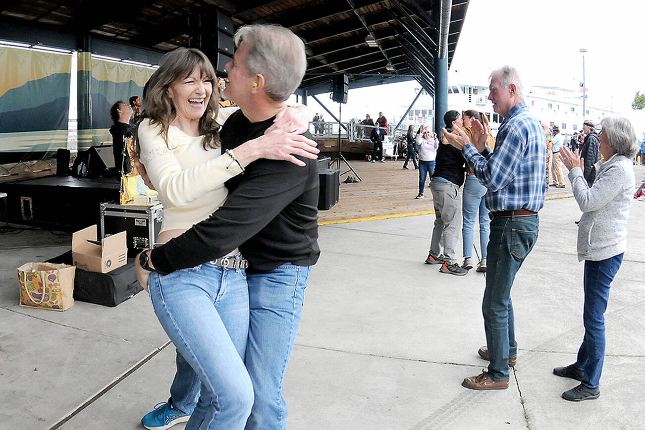 Lorna Kay Smith and Philip Wade, both of Sequim, dance to the music of Rose’s Pawn Shop to kick off the Concert on the Pier music series on Wednesday evening at Port Angeles City Pier. The series, presented by the Juan de Fuca Foundation and sponsored by Strait View Credit Union, D.A. Davidson & Co., 102.1 FM The Strait and Peninsula Daily News, continues at 6 p.m. Wednesday with the Wild Rumors band. (Keith Thorpe/Peninsula Daily News)