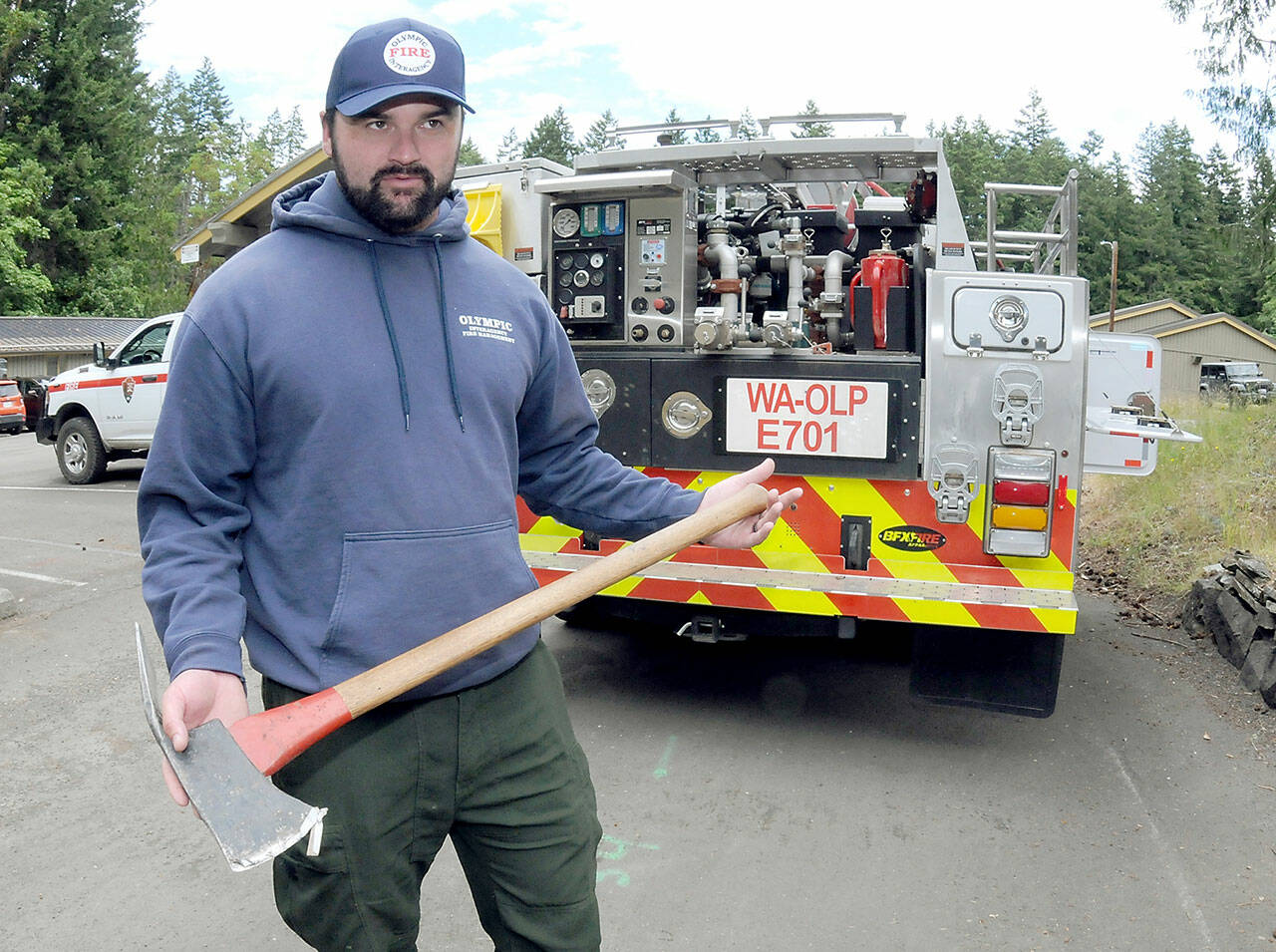 Jeff Bortner, Interagency Fire Management Officer employed by Olympic National Park, explains the history of a Pulaski tool often carried by wildland firefighters. (Keith Thorpe/Peninsula Daily News)
