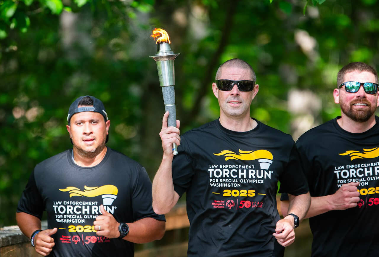 Representatives from the Peninsula Communications team and Port Angeles Police Department were among those from other Clallam County law enforcement agencies who participated in the 2025 Special Olympics Law Enforcement Torch Run. (Jesse Major)