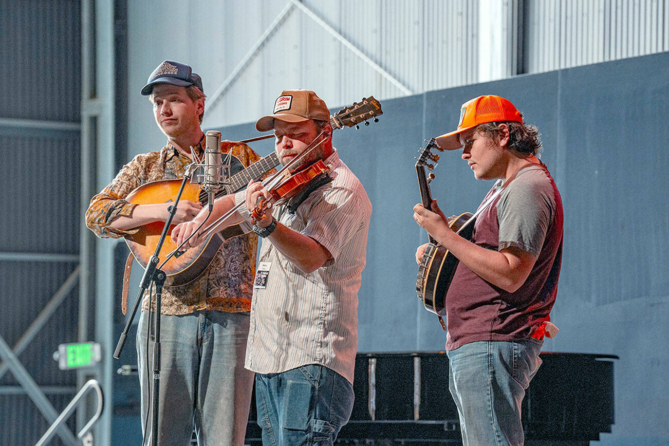 The Tennessee Hillbuddies, from left, Conner Vlietstra, Henry Barnes and Trevor Holder, perform during a concert at McCurdy Pavilion at Fort Worden State Park on Friday. (Steve Mullensky/for Peninsula Daily News)