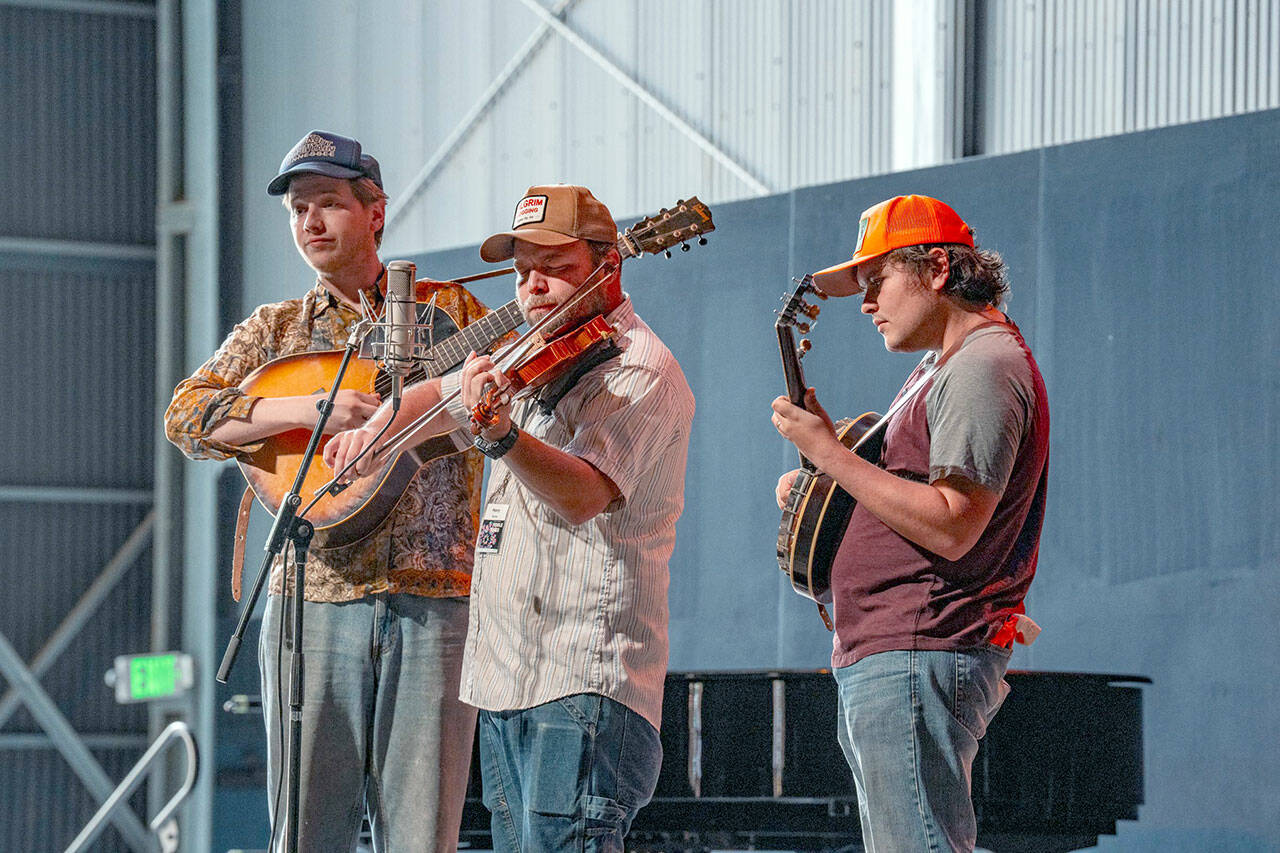 The Tennessee Hillbuddies, from left, Conner Vlietstra, Henry Barnes and Trevor Holder, perform during a concert at McCurdy Pavilion at Fort Worden State Park on Friday. (Steve Mullensky/for Peninsula Daily News)