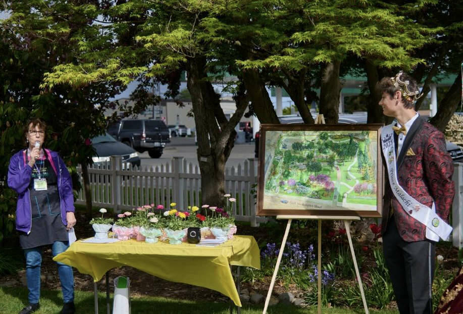 Suzan Mannisto, co-manager of Pioneer Memorial Park, introduces the “Pathway Accessible to All Project” as Sequim Irrigation Festival Prince Malachi Byrne looks on. (Sequim Prairie Garden Club)