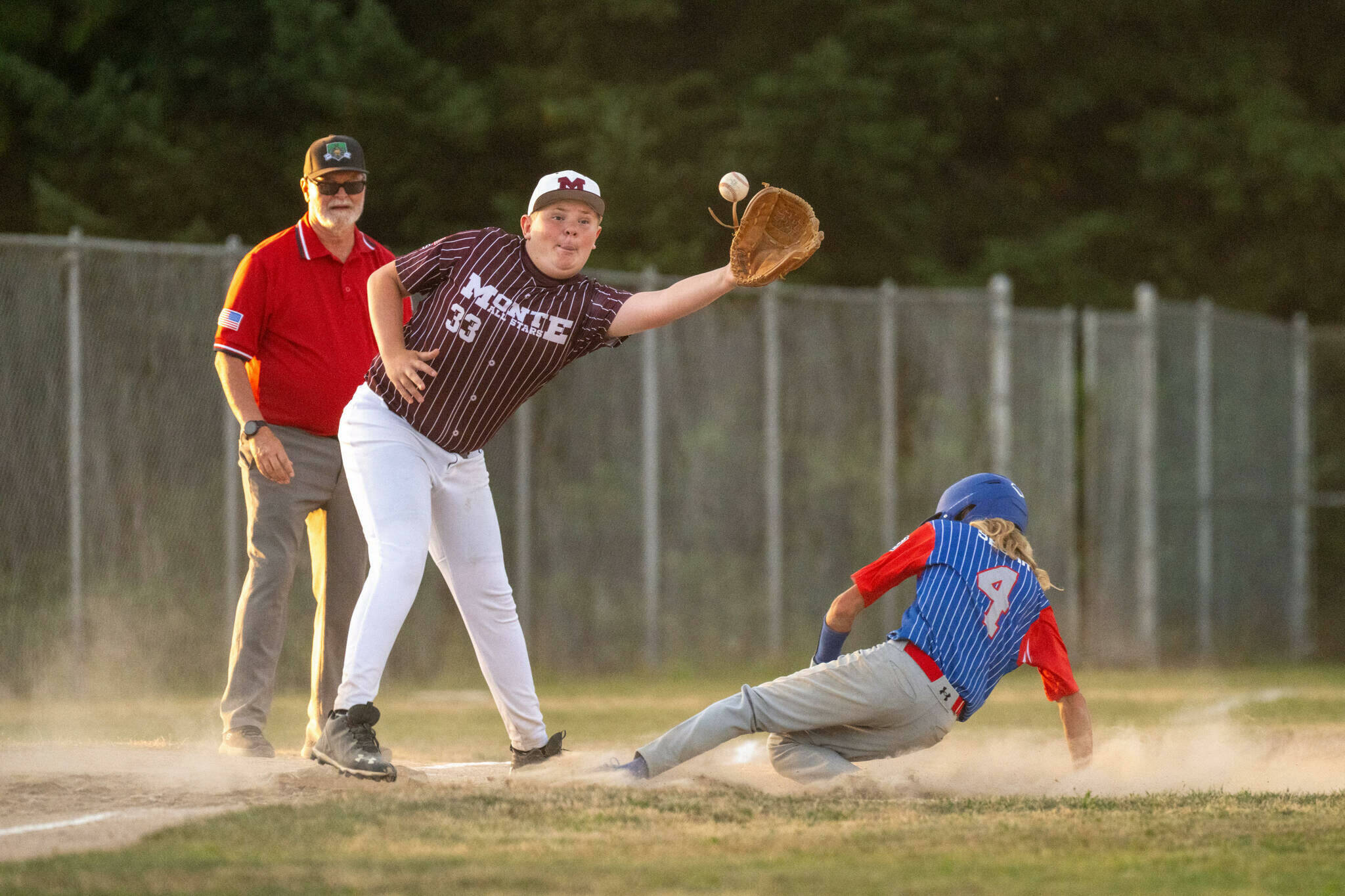 Above, East Jefferson’s Logan Segar slides safely into third base ahead of the tag during the team’s 2025 Washington State Juniors tournament 17-0 win over Montesano over the weekend. East Jefferson is 2-0 in the tournament with a spot in the West Region Tournament in Bend, Ore., on the line. (The Aberdeen Daily World)