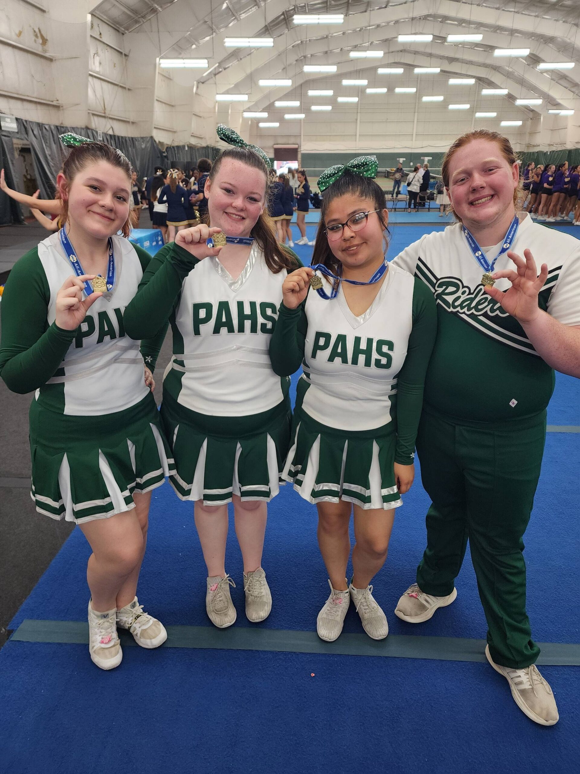 Port Angeles High School senior cheerleaders, from left, Madison Bishop, Addisen McNeece, Melia Webber and Jack Root have been invited as All-America cheerleaders to participate in the Pearl Harbor Memorial Parade in Honolulu, Hawaii, from Dec. 3-8. To help the group raise funds, call 360-461-0812.