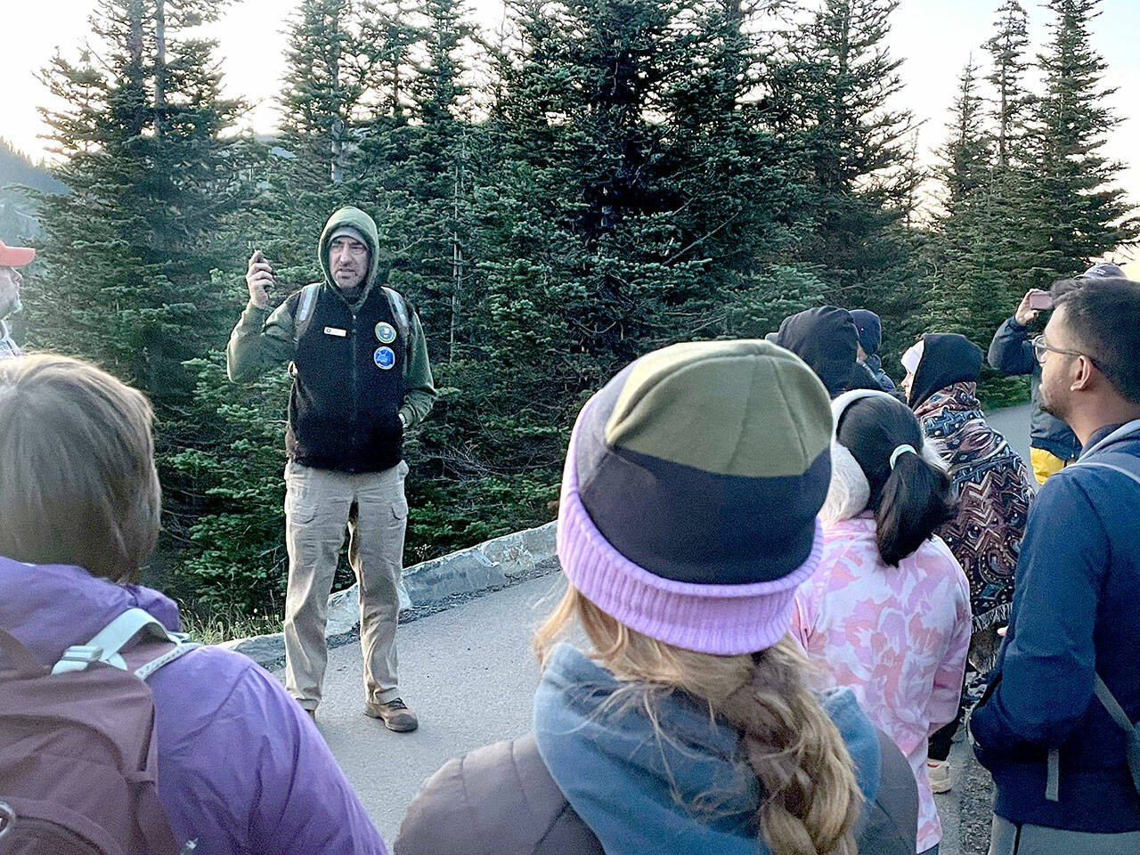 John Goar speaks to a group of visitors before leading them on a moonlit hike up Hurricane Hill for a tour of the constellations. Goar is a volunteer who leads the full moon hikes and dark sky telescope tours that are part of the astronomy program at Hurricane Ridge. (Paula Hunt/Peninsula Daily News)