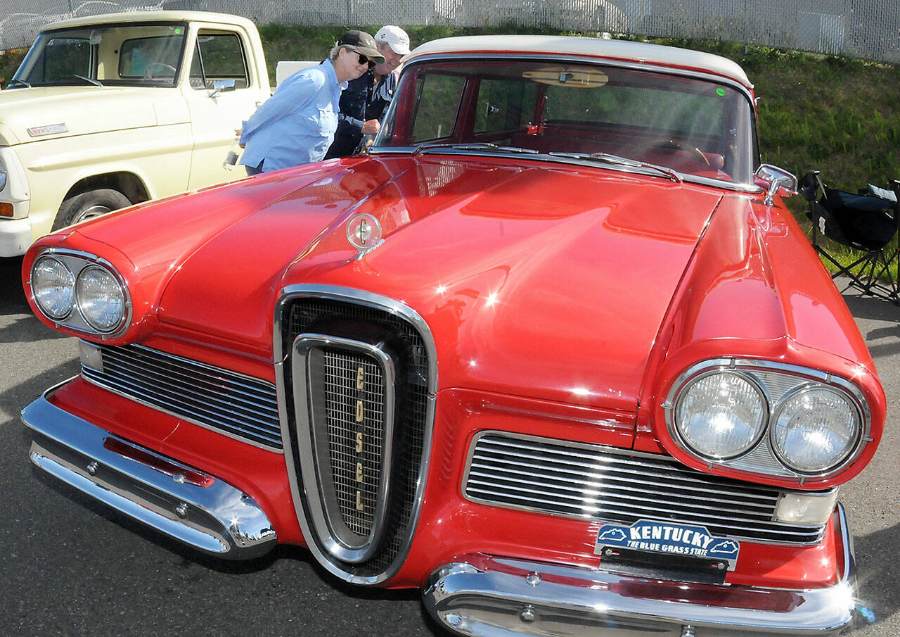 Kelly and Dan Freeman of Port Ludlow examine a 1958 Edsel on display during Friday evening’s 29th annual Ruddell Cruise-In at Ruddell Auto in Port Angeles. The event featured hundreds of antique and vintage automobiles from across the region as well as food, music and other activities. (Keith Thorpe/Peninsula Daily News)