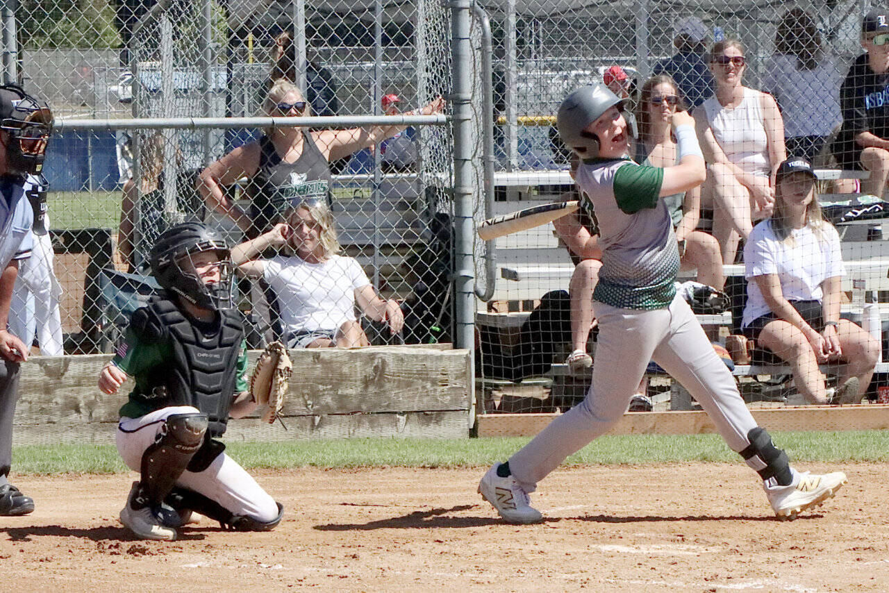 Port Angeles U11’s Mason Henderson hits a RBI to right field as the local team played the Lynden Lobos in the championship game, falling 9-5. (Dave Logan/for Peninsula Daily News)