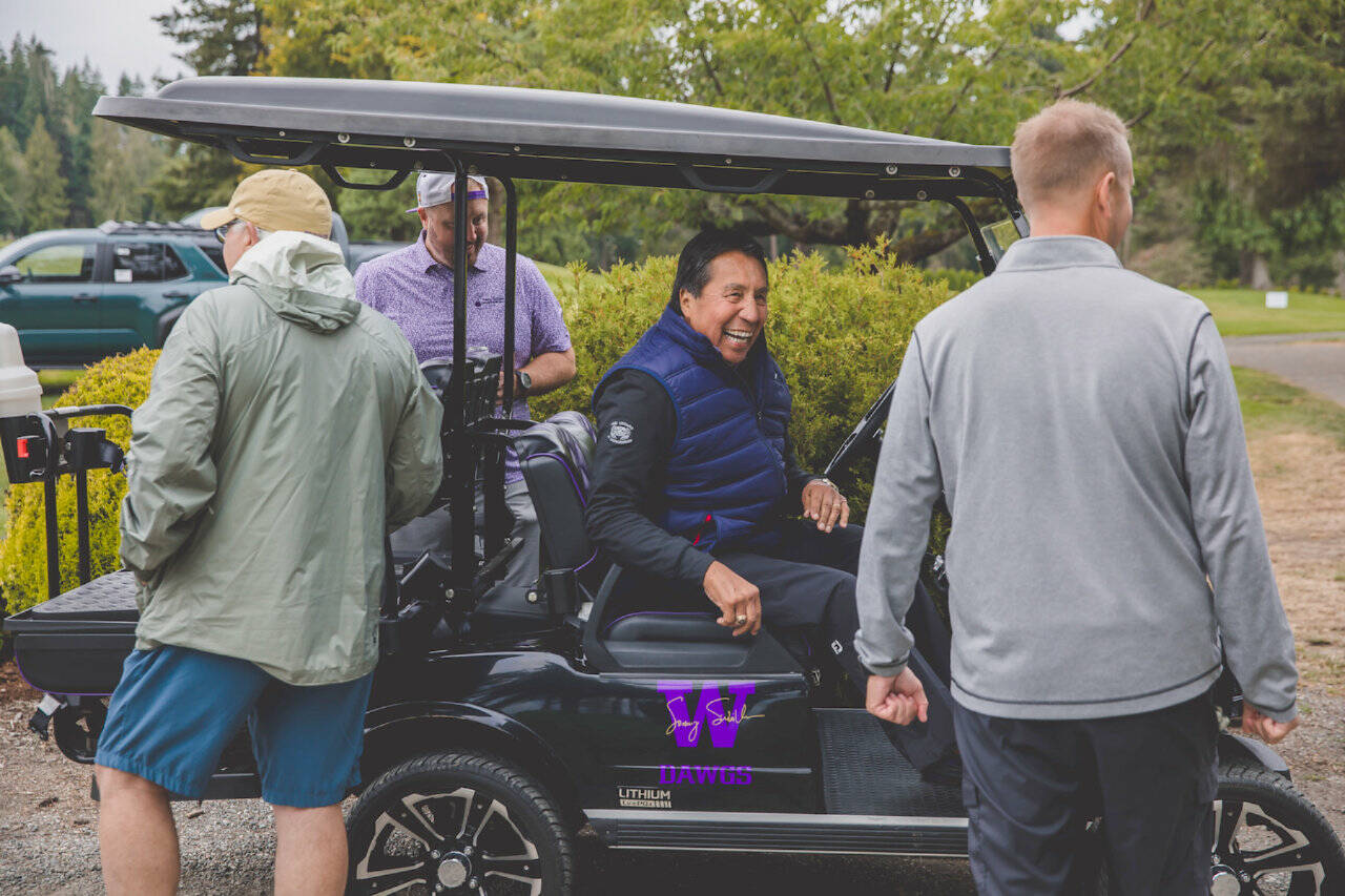 Former University of Washington quarterback Sonny Sixkiller, in cart, hosted his 14th annual celebrity golf tournament at Cedars at Dungeness this weekend. (Lexie Winters)
