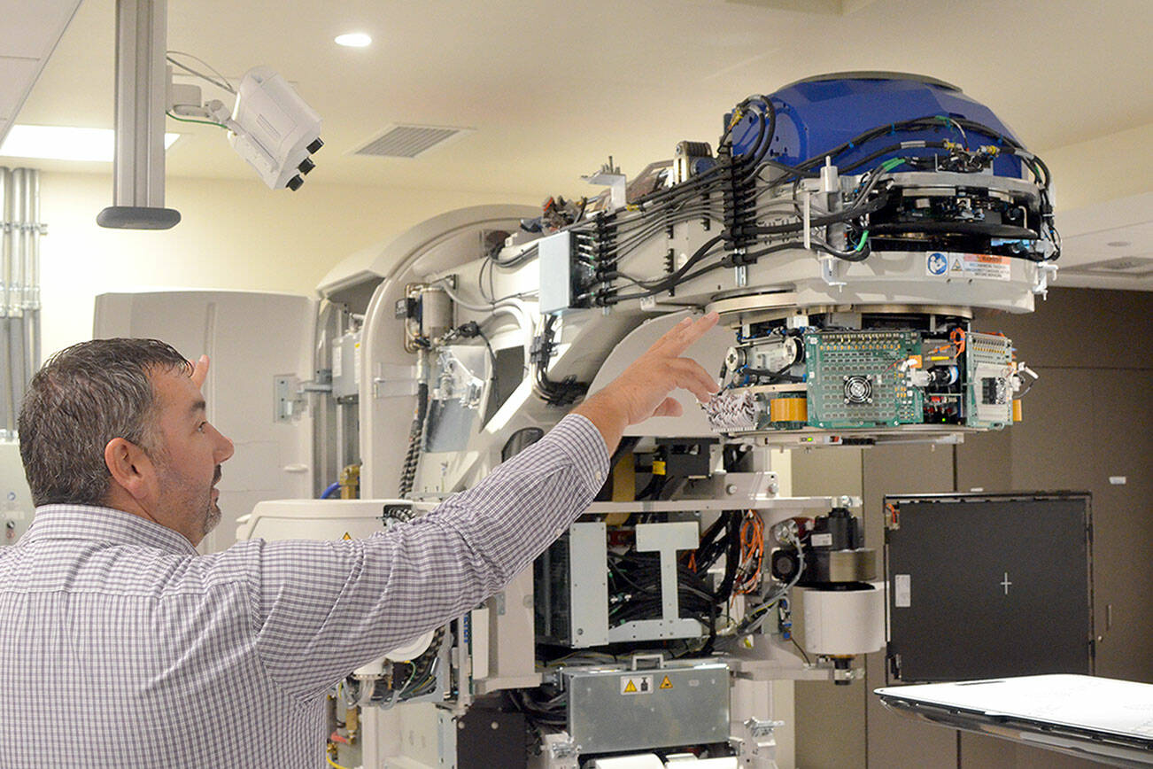 Jefferson Healthcare Chief Operations Officer Jacob Davidson with the hospital’s new linear accelerator, which should be ready to use in October. (Elijah Sussman/Peninsula Daily News)