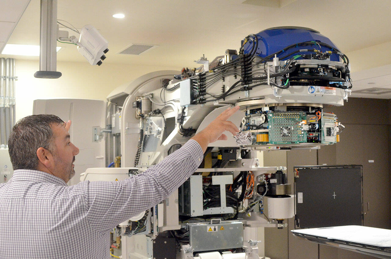 Jefferson Healthcare Chief Operations Officer Jacob Davidson with the hospital’s new linear accelerator, which should be ready to use in October. (Elijah Sussman/Peninsula Daily News)