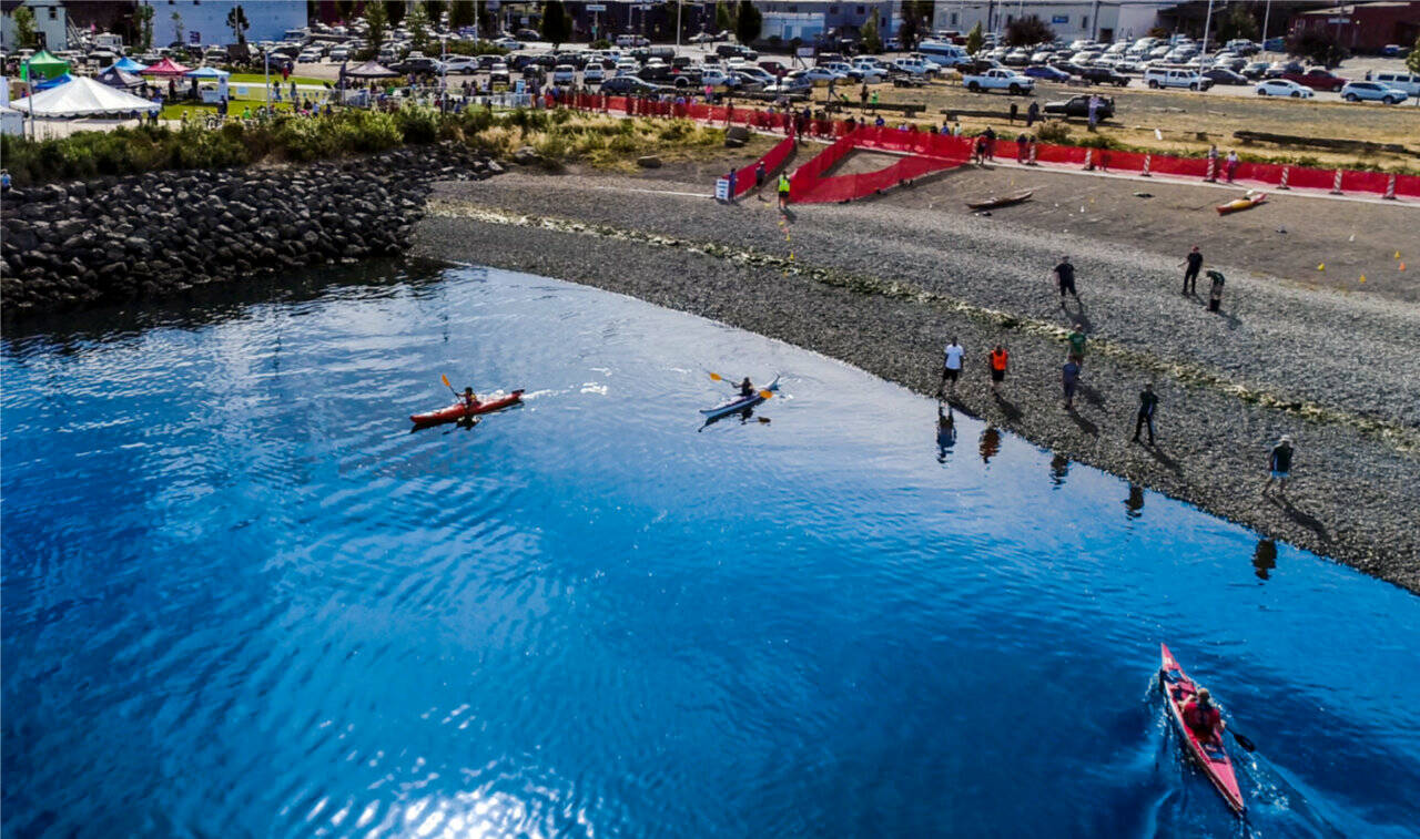 Competitors in the Big Hurt transfer to kayaks at Port Angeles’ Pebble Beach. (Matt Sagen/Cascadia Films)