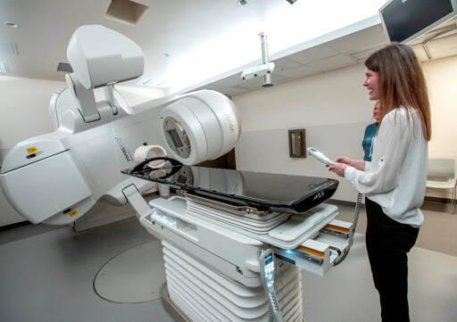 Dr. Sabrina Prime, a radiation oncologist at Jefferson Healthcare, demonstrates the new $2.5 million linear accelerator that will be used in the treatment of cancer patients during a dedication and open house on Sunday in Port Townsend. (Steve Mullensky/for Peninsula Daily News)