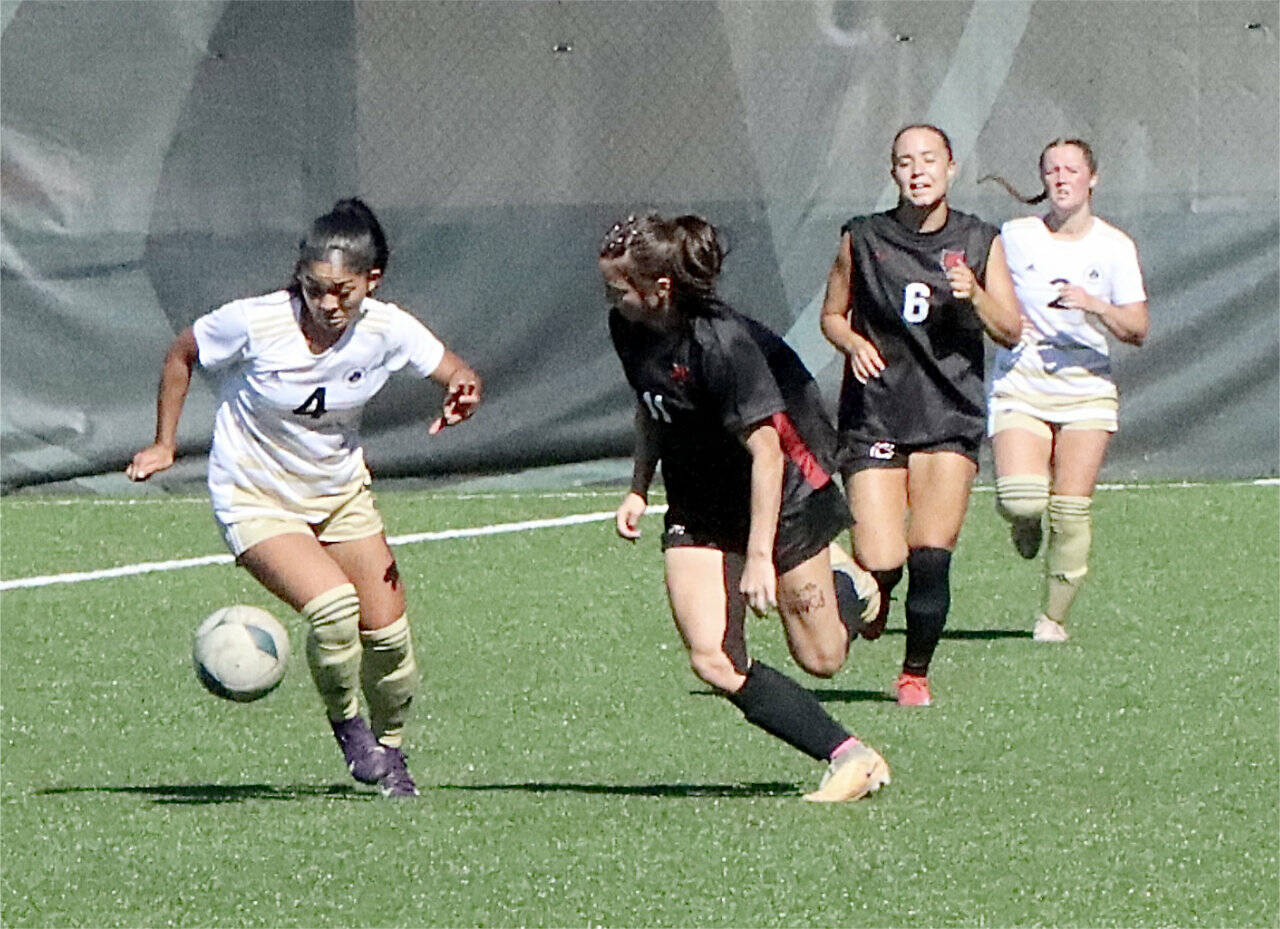 Peninsula College women’s newcomer Kamalani Yamashita (4) from Hawaii battles for the ball against Central Washington in a scrimmage held last week at Wally Sigmar Field. In the background is Peninsula’s Olivia Danks (2). (Dave Logan/for Peninsula Daily News)