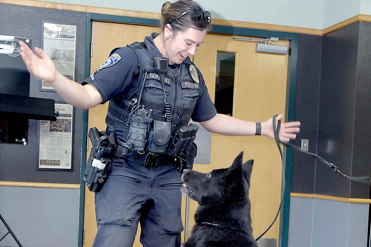 Port Angeles Police Officer Whitney Fairbanks plays with her dog Copper during a presentation in September 2024. (Keith Thorpe/Peninsula Daily News)