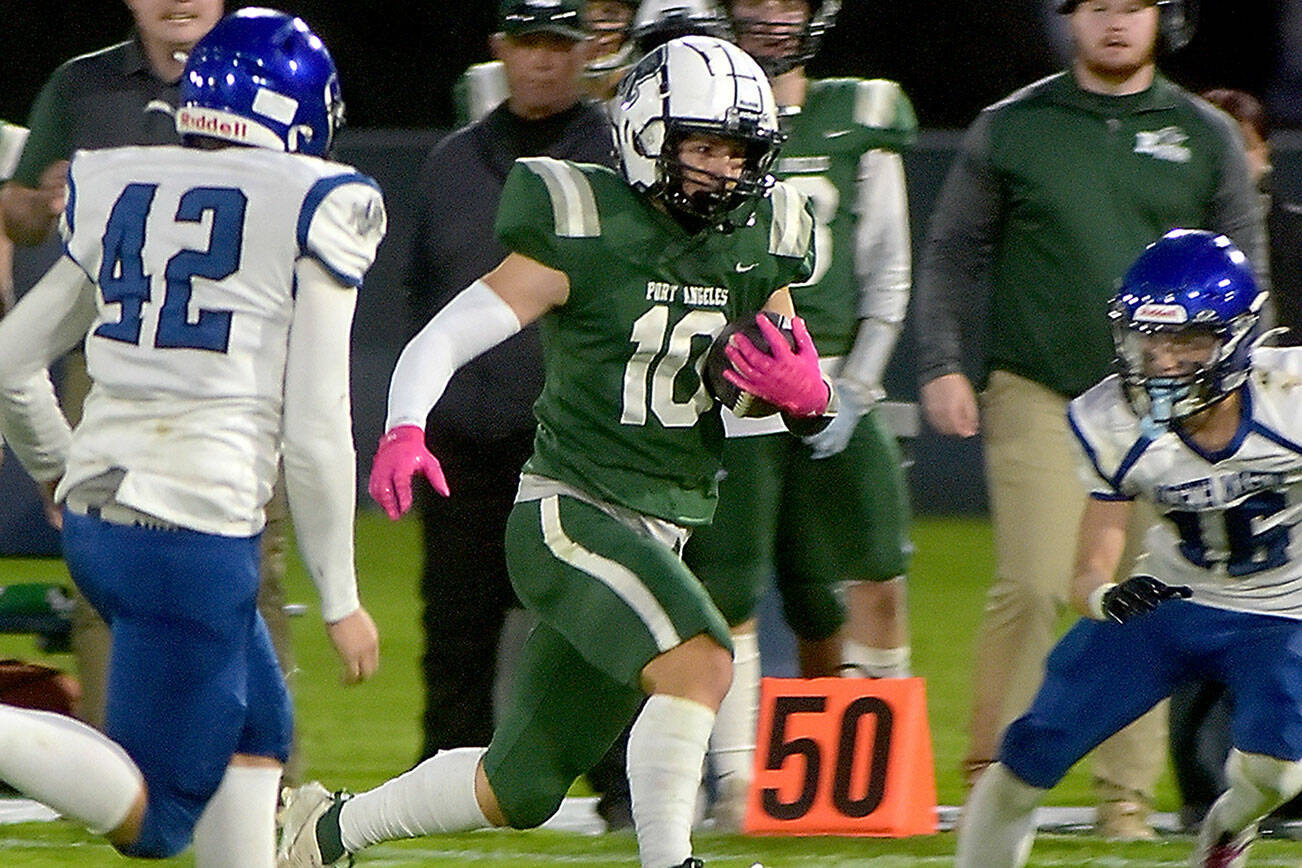 KEITH THORPE/PENINSULA DAILY NEWS
Port Angeles' Ian Smithson, center, slips past the defense of North Mason's Robert Hickerson, left, and Chris Arbogast during Friday night's game at Port Angeles Civic Field.